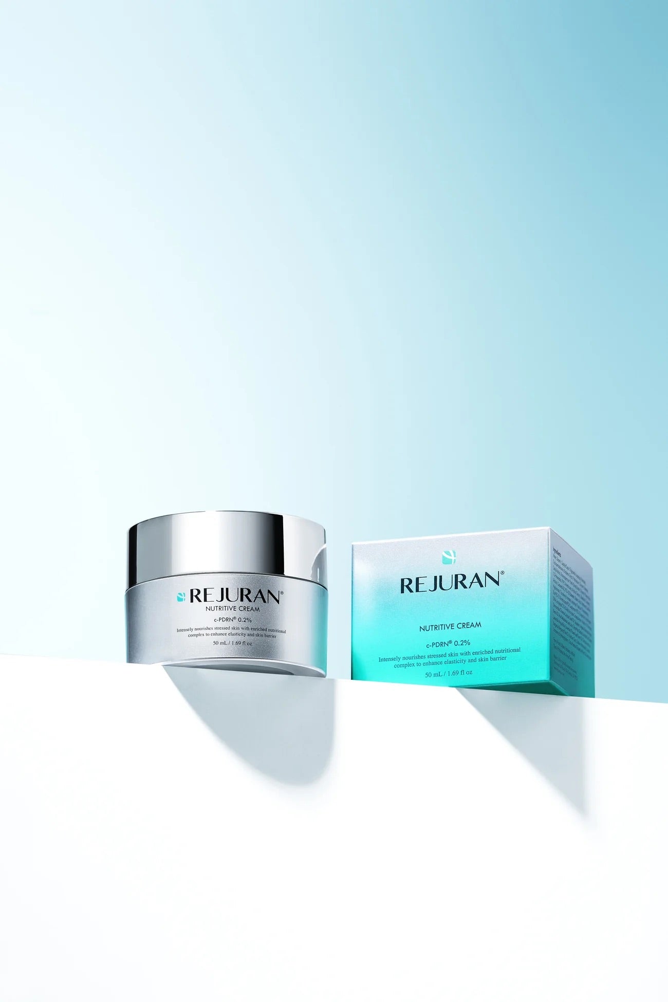 Rejuvenating cream jar and box with Rejuran branding on a gradient blue background